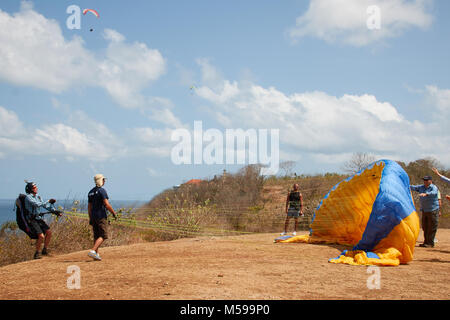 Paragliding on sunny day, flying in the sky, at Bali Stock Photo