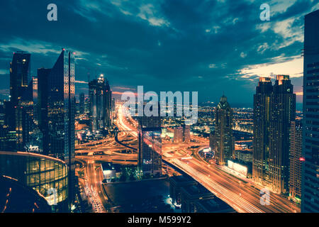 Bird's eye view of Dubai skyline and rush hour traffic in downtown at night Stock Photo