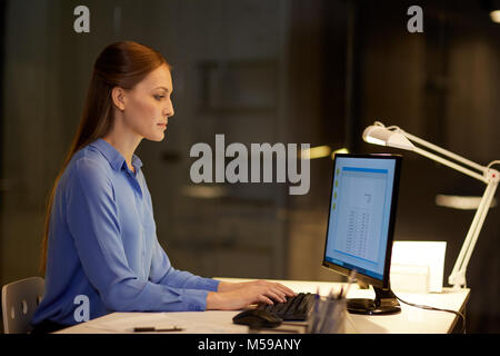 businesswoman with papers working at night office Stock Photo