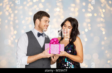 happy couple with gift box at birthday party Stock Photo