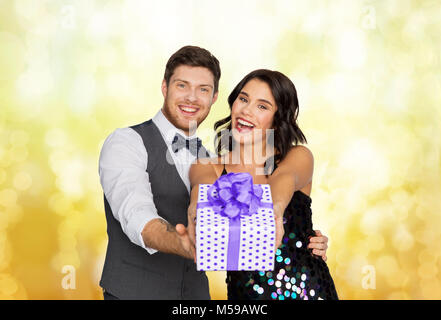 happy couple with gift box at birthday party Stock Photo