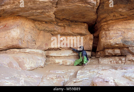 Libya. Ghat. Akakus National Park. Prehistoric rock art paintings. Rock-Art Sites of Tadrart Acacus. Tuareg man. Unesco, World Heritage Site. Stock Photo