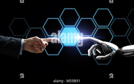robot and human hand touching network hologram Stock Photo