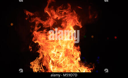 Fire with colorful flames. Big blaze on black background. Close up view with details, banner, space for text. Stock Photo