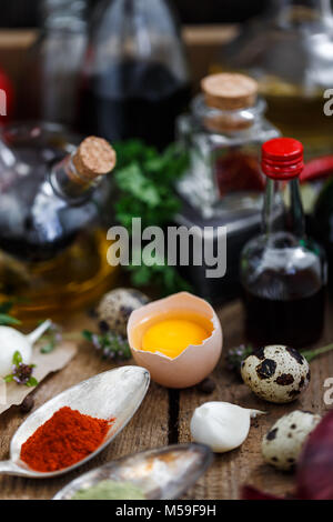 Sauces, oils and spices in a old wooden box. Stock Photo
