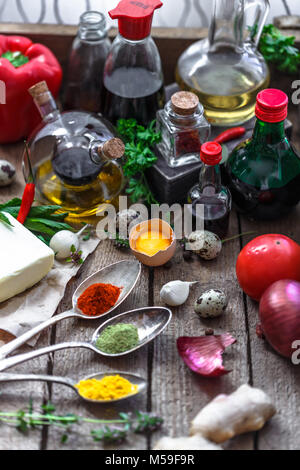 Various spices, oils and sauces selection on wooden background. Stock Photo