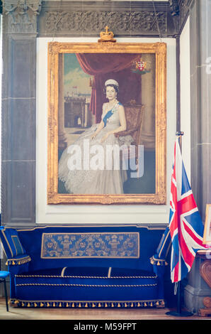 Portrait of Queen Elizabeth II (the second) and a Union Jack flag in the Mayor's Office inside the Civic Centre, Southampton City Council, England Stock Photo