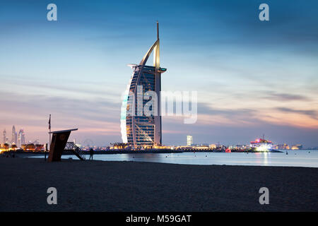 DUBAI, UAE - FEBRUARY 2018 :The world's first seven stars luxury hotel Burj Al Arab at night seen from Jumeirah public beach in Dubai, United Arab Emi