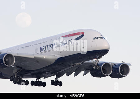 British Airways Airbus A380 is shown arriving at LAX at sunset time. The rising moon is visible in the background. Stock Photo