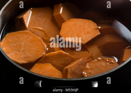 Chunks of yams or sweet potatoes boiling in a stock pot Stock Photo