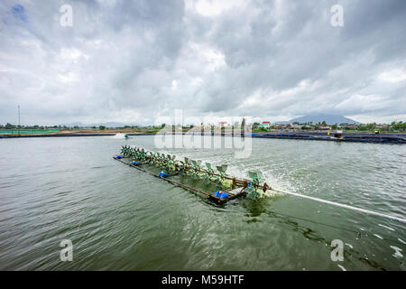 * Aerator turbine wheel oxygen fill ins Into lake water in Shrimp farm at Ba Ria, Vung Tau, Vietnam Stock Photo