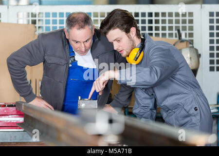 carpenter with apprentice in training period Stock Photo