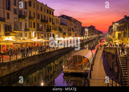 Naviglio Grande canal with restaurants and tourists in Milan, Italy in the evening Stock Photo