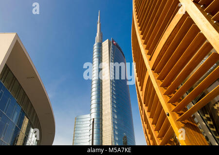 Modern architecture - UniCredit Tower or Torre UniCredit at Porta Nuova business district, Milan, Italy, with the wooden UniCredit Pavilion building Stock Photo