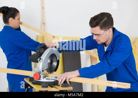 student in carpentry class using circular saw Stock Photo
