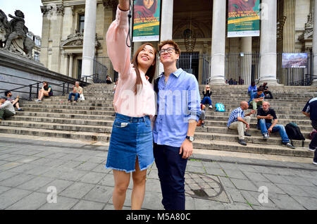 Brussels, Belgium. Asian couple taking a selfie in front of the Bourse Stock Photo