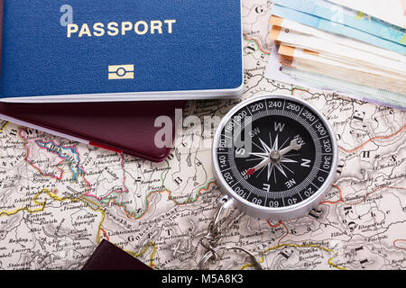 Elevated View Of Passport And Compass On Map Stock Photo