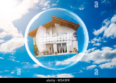 Close-up Of House Inside Bubble Against Cloudy Sky Stock Photo