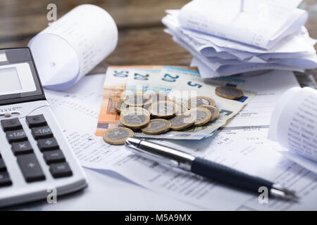 High Angle View Of Currency With Calculator And Pen On Receipt Stock Photo