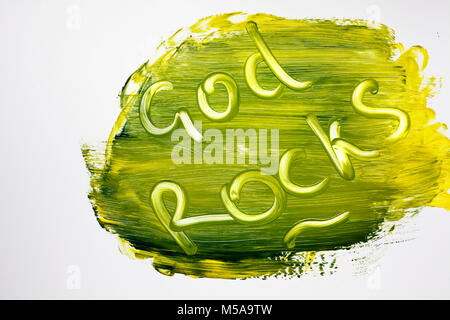 In brightly colored paint, a God Rocks message is written Stock Photo