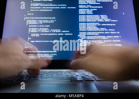Close-up Of A Hacker's Hand Using Laptop Stock Photo