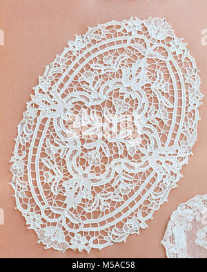 Detail of  a handmade oval table mat  of Burano lace on Burano Island, Venice, Veneto, Italy displayed outside a specialist shop offering demonstratio Stock Photo