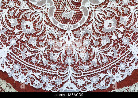 Detail of an intricate  round  handmade Burano lace tablecloth on Burano Island, Venice, Veneto, Italy made using a needle and thread by the ladies of Stock Photo