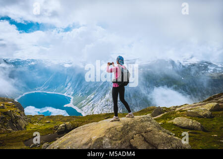 Nature photographer tourist near Norway lake Stock Photo