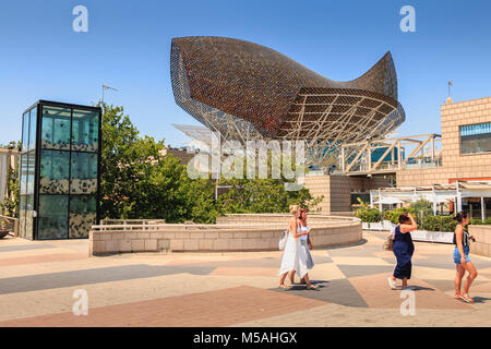 Barcelona, Spain - June 21, 2017 : in the middle of the day, tourists stroll in front of the fish of the American architect Frank Gehry built on the o Stock Photo