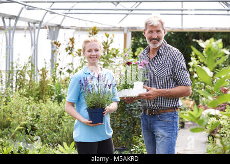 Portrait Of Male Customer With Sales Assistant At Garden Center Stock Photo