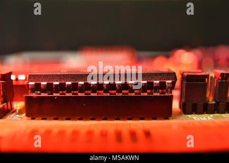 close up of a microchip in red light Stock Photo