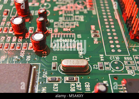 Close up of a circuit board with electronical components in red light Stock Photo