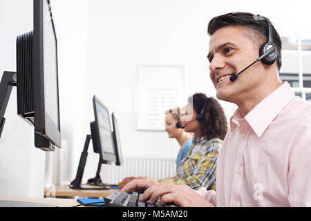Male Customer Services Agent In Call Centre Stock Photo