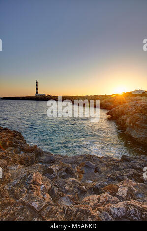 Cap d'Artrutx Lighthouse, located in the extreme south-western point of the island adjacent to the larger resort of Cala en Bosch, Menorca,Balearic Is Stock Photo