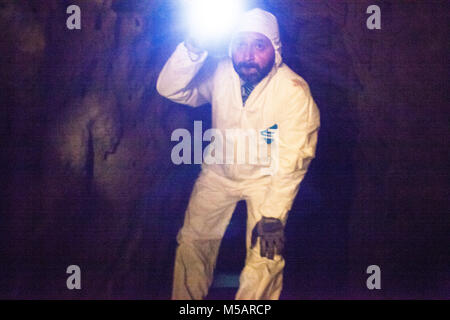 An investigator in the farm house tunnel used by Joaquin 'El Chapo' Guzman to escape Altiplano prison near Toluca, Mexico on Wednesday July 15, 2015. The notorious cartel leader Joaquin 'El Chapo' Guzman escaped from the maximum security prison four days ago through a tunnel. This is the second time he has escaped a Mexican prison. Stock Photo