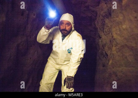 An investigator in the farm house tunnel used by Joaquin 'El Chapo' Guzman to escape Altiplano prison near Toluca, Mexico on Wednesday July 15, 2015. The notorious cartel leader Joaquin 'El Chapo' Guzman escaped from the maximum security prison four days ago through a tunnel. This is the second time he has escaped a Mexican prison. Stock Photo