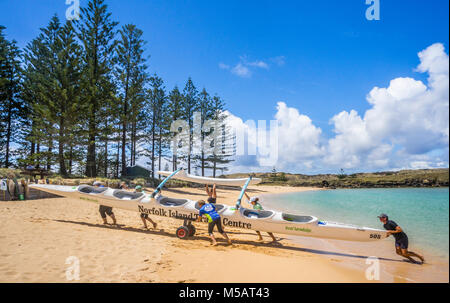 Norfolk Island, Australian external territory, outrigger canoe crew landing on the beach of Emily Bay Stock Photo