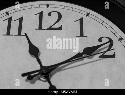 Closeup on the pointers of a clock marking ten minutes after eleven o'clock - black and white rendering Stock Photo