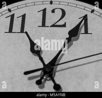 Closeup on the pointers of a clock marking five minutes after eleven o’clock - black and white rendering Stock Photo