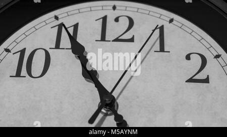 Closeup on the pointers of a clock marking five minutes before eleven o’clock - black and white rendering Stock Photo