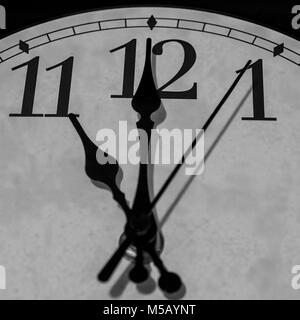 Closeup on the pointers of a clock marking eleven o’clock - black and white rendering Stock Photo