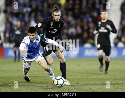 Leganes, Madrid, Spain. 21st Feb, 2018. Bale (Real Madrid) competes for the ball with Bustinza of during the match between Leganes vs Real Madrid at the Estadio Butarque.Final Score Leganes 1 Real Madrid 3. Credit: Manu Reino/SOPA/ZUMA Wire/Alamy Live News