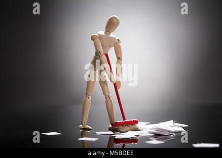 Wooden Dummy Figure Cleaning White Messy Paper On Floor Stock Photo