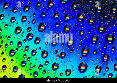 Water droplets on the shiny surface of a DVD. England UK GB Stock Photo