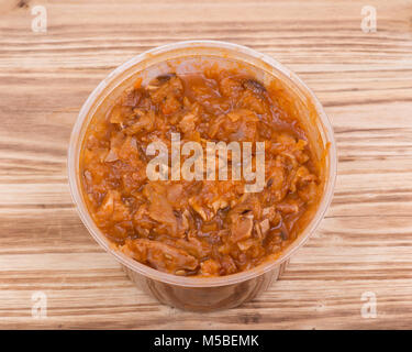 Home made cabbage stew in bpa free plastic container on vintage wooden background Stock Photo