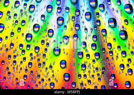 Water droplets on the shiny surface of a DVD. England UK GB Stock Photo