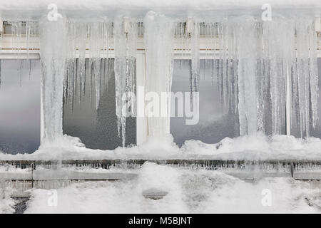 Icicle windows on winter time. Freeze temperatures backgrounds