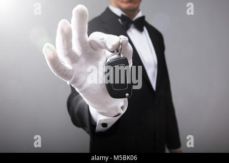 Close-up Of A Waiter's Hand Holding Car Key Stock Photo