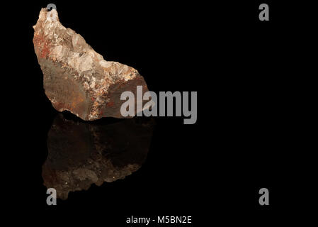 Haematite or hematite, iron ore mineral, form of iron oxide isolated on black background. Rhombohedral lattice system structure. Rocks and minerals Stock Photo