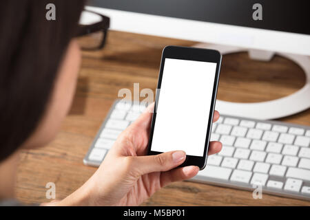 Close-up Of A Female Holding Cell Phone With Blank White Screen Stock Photo